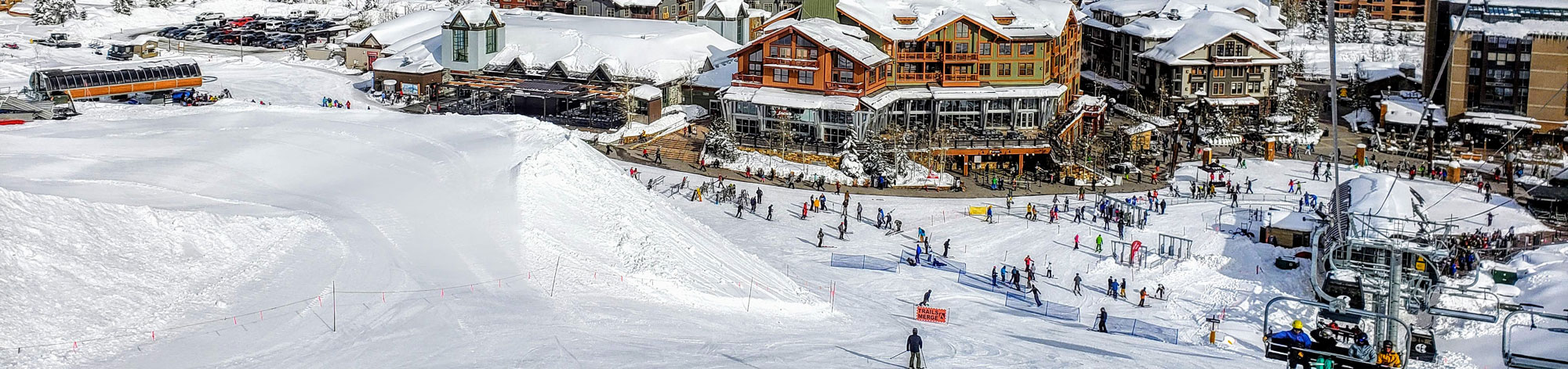 people skiing down the skiing platform and resorts along side the skiing platform
