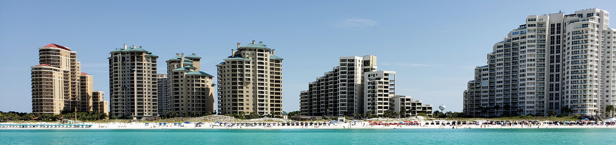 A view of 6 multi-story resorts along side the beach